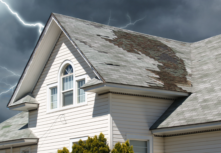 Residential roof damaged by severe storm weather