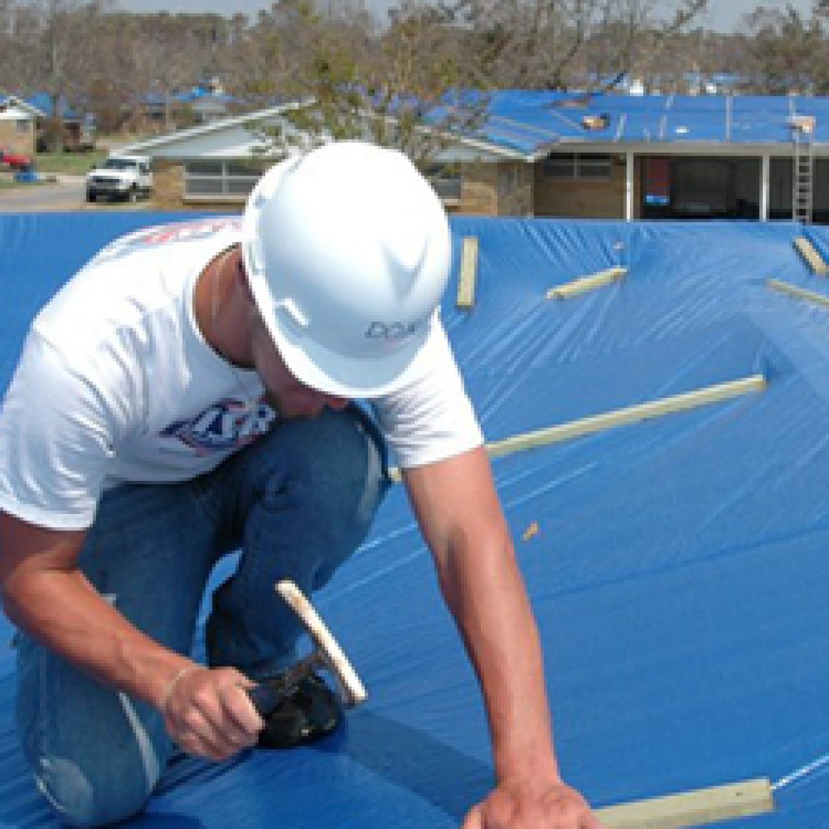 Emergency roof tarping on a damaged home in Palm Bay FL