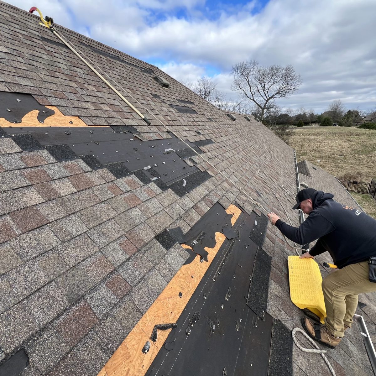 Storm damage roof repair on a damaged shingle roof in Palm Bay FL