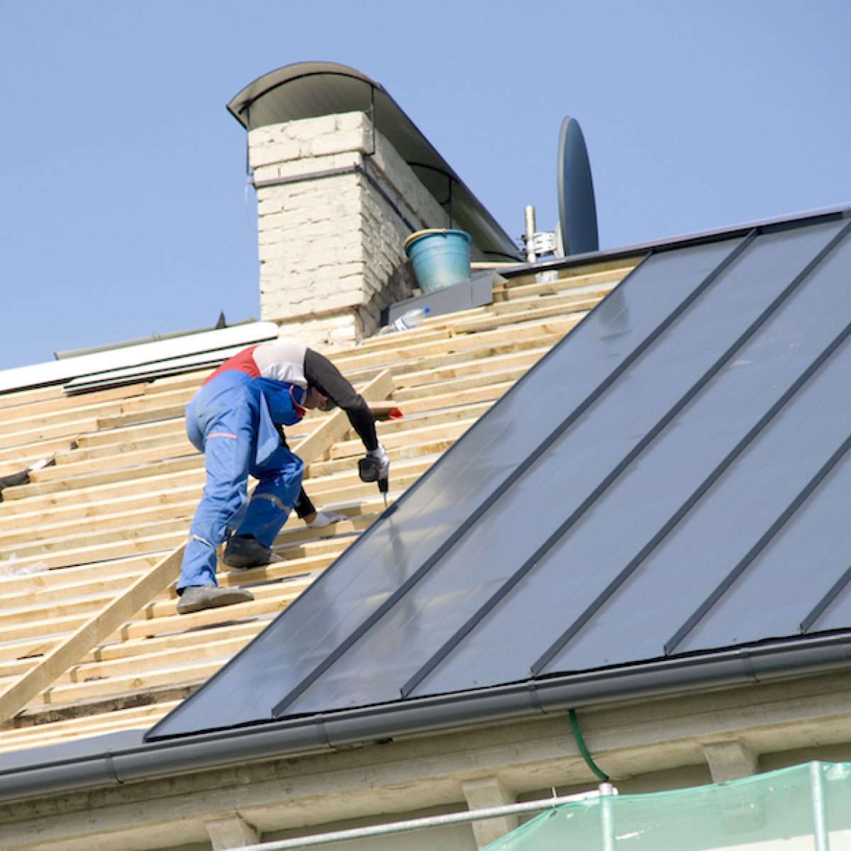 Roofing contractor installing a new residential roofing system